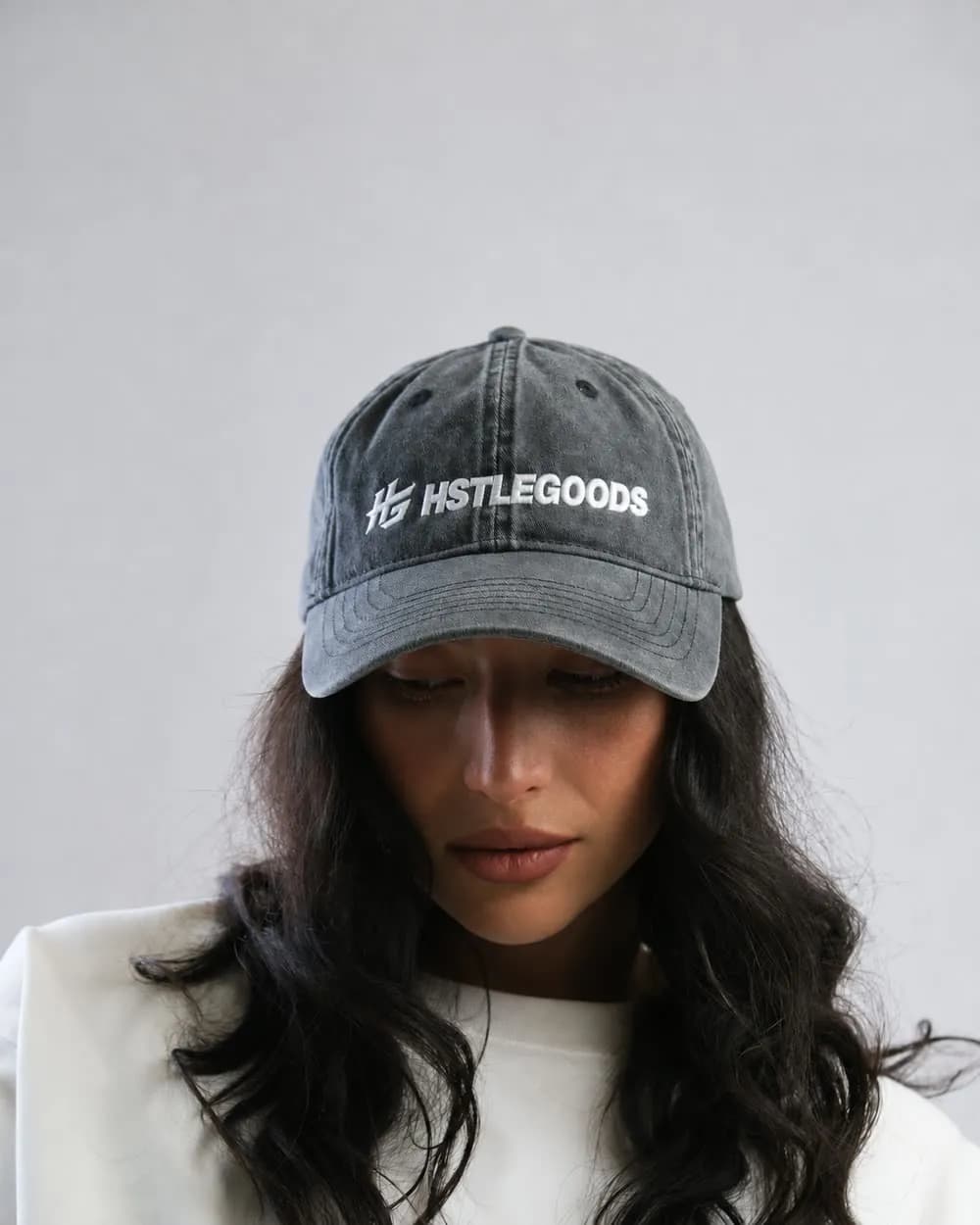 HSTLEGOODS logo embroidered on a washed grey cap